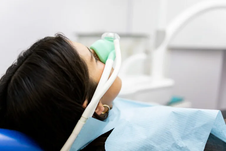 patient at dental office receiving dental sedation via a nasal mask